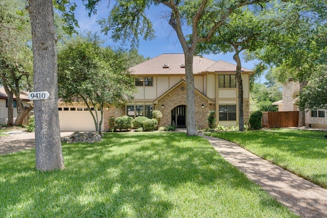 9410 Topridge Dr, Austin, TX 78750 - english style home with an attached garage, stucco siding, and brick siding