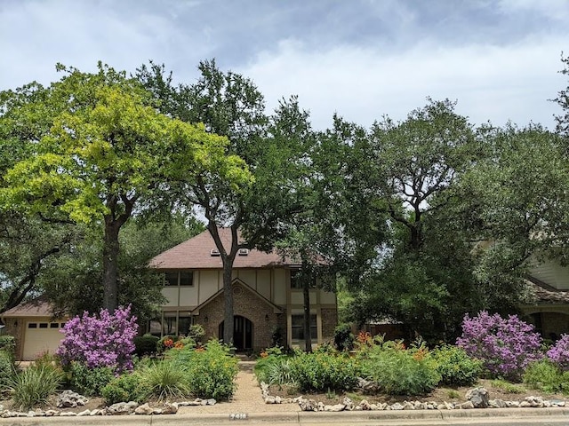 9410 Topridge Dr, Austin, TX 78750 - tudor-style house featuring brick siding and an attached garage