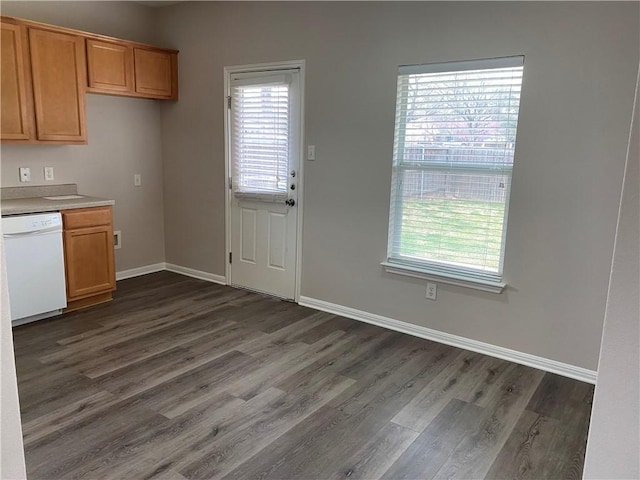 2700 Saddle Blanket Pl, Leander, TX 78641 - kitchen with dishwasher, dark wood-type flooring, light countertops, and brown cabinetry