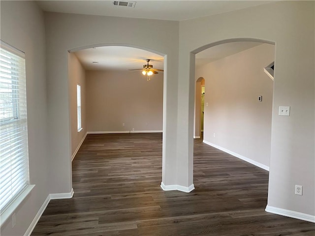 2700 Saddle Blanket Pl, Leander, TX 78641 - empty room featuring ceiling fan, arched walkways, and dark wood-type flooring