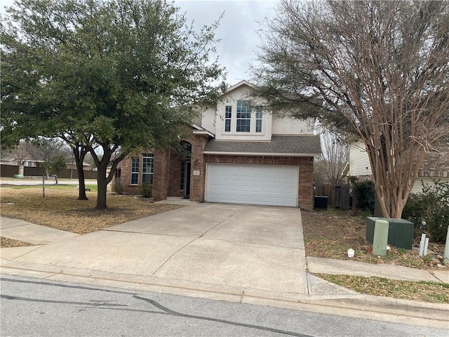 2700 Saddle Blanket Pl, Leander, TX 78641 - traditional home with brick siding, driveway, a garage, stucco siding, and roof with shingles