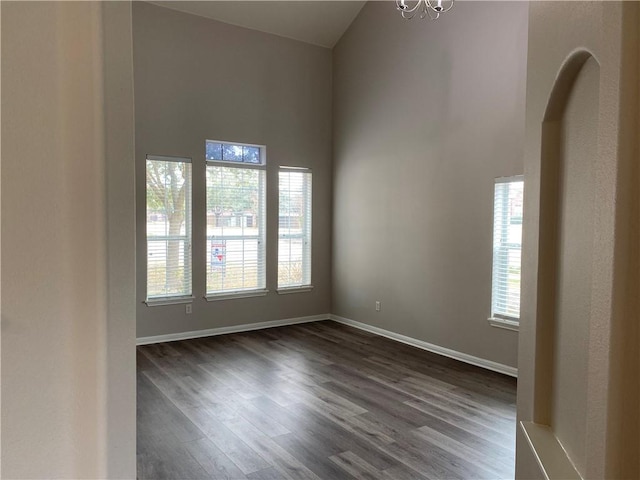 2700 Saddle Blanket Pl, Leander, TX 78641 - unfurnished room with dark wood-style flooring, a chandelier, and a towering ceiling