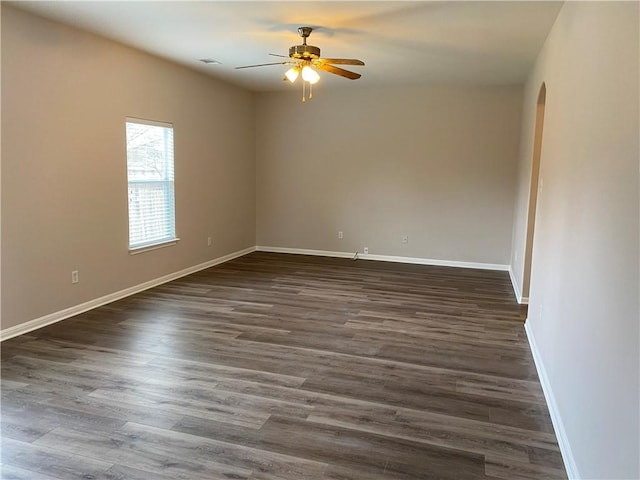 2700 Saddle Blanket Pl, Leander, TX 78641 - empty room featuring ceiling fan, arched walkways, and dark wood finished floors