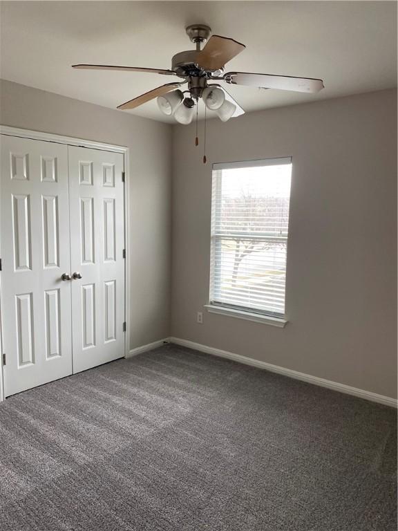 2700 Saddle Blanket Pl, Leander, TX 78641 - unfurnished bedroom featuring carpet, a closet, and a ceiling fan