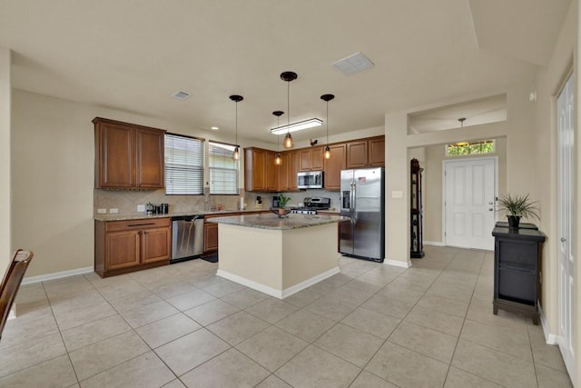 201 Trestle Tree, San Marcos, TX 78666 - kitchen with stainless steel appliances, light tile patterned flooring, tasteful backsplash, light stone counters, and brown cabinetry