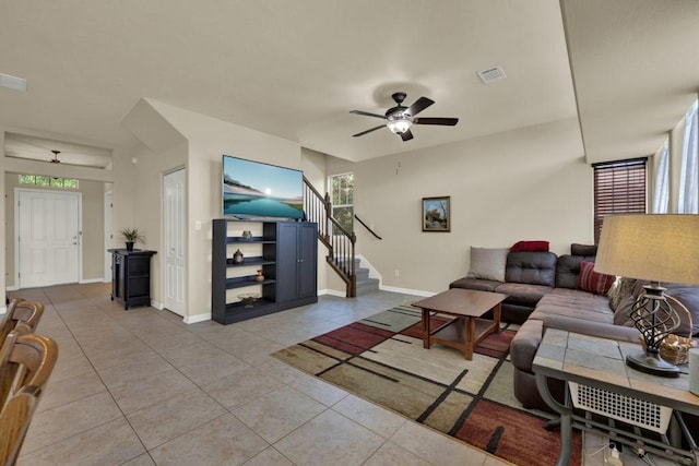 201 Trestle Tree, San Marcos, TX 78666 - living room featuring light tile patterned floors, a ceiling fan, plenty of natural light, and stairway