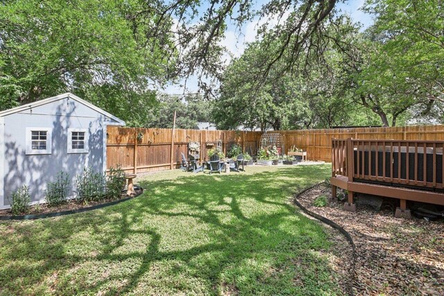 9100 Bill Hickcock Pass, Austin, TX 78748 - fenced backyard with an outdoor structure and a wooden deck