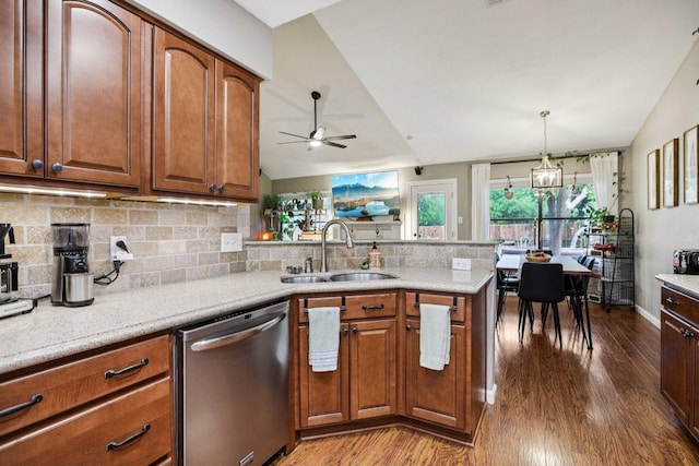9100 Bill Hickcock Pass, Austin, TX 78748 - kitchen with stainless steel dishwasher, vaulted ceiling, dark wood-style flooring, a peninsula, and tasteful backsplash