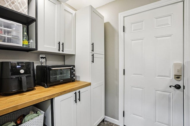 9100 Bill Hickcock Pass, Austin, TX 78748 - kitchen with wood counters and white cabinetry