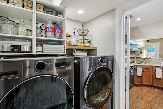 9100 Bill Hickcock Pass, Austin, TX 78748 - laundry area with separate washer and dryer, wood finished floors, and recessed lighting