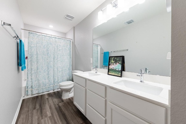 1805 Bogata Ln, Leander, TX 78641 - bathroom featuring wood finished floors, double vanity, and shower / bath combo