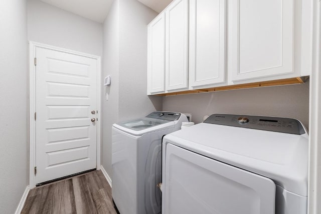 1805 Bogata Ln, Leander, TX 78641 - washroom featuring cabinet space, washer and clothes dryer, and dark wood-type flooring