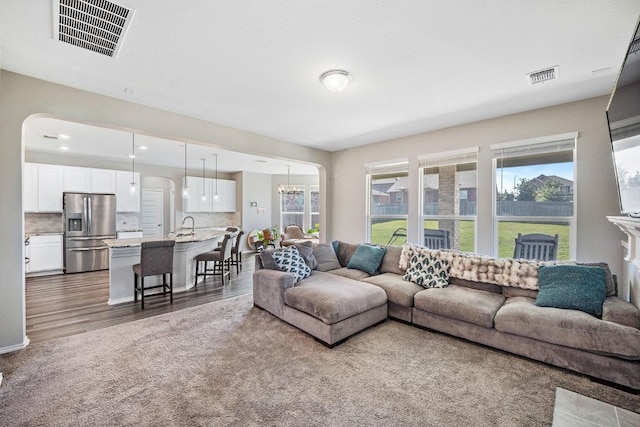 1805 Bogata Ln, Leander, TX 78641 - living room with dark wood-style flooring and arched walkways