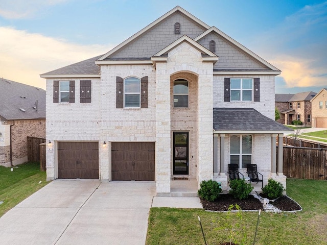 1805 Bogata Ln, Leander, TX 78641 - view of front facade featuring driveway, covered porch, brick siding, an attached garage, and roof with shingles