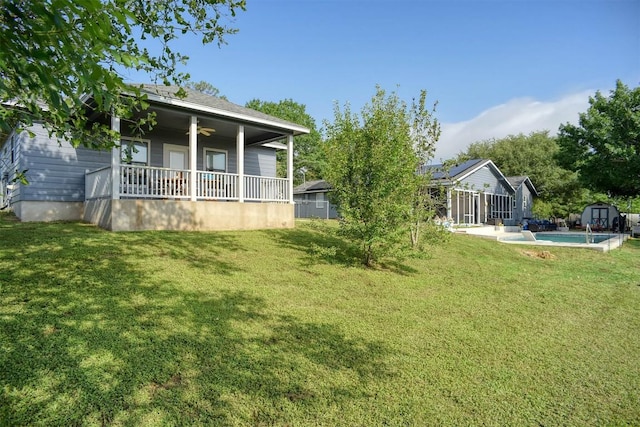 569 Mcallister Rd, Bastrop, TX 78602 - view of green lawn with a shed and a ceiling fan