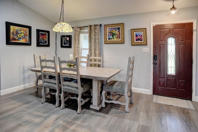 569 Mcallister Rd, Bastrop, TX 78602 - dining area with wood finished floors, vaulted ceiling, and plenty of natural light