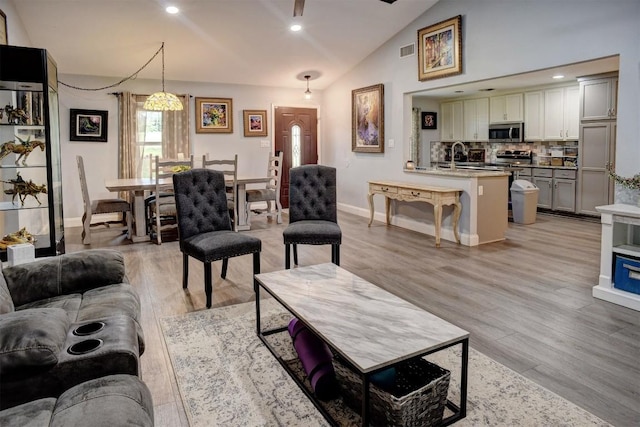 569 Mcallister Rd, Bastrop, TX 78602 - living area with lofted ceiling, light wood-type flooring, and recessed lighting