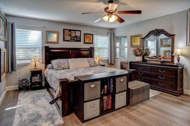 569 Mcallister Rd, Bastrop, TX 78602 - bedroom with multiple windows, light wood-type flooring, and ceiling fan
