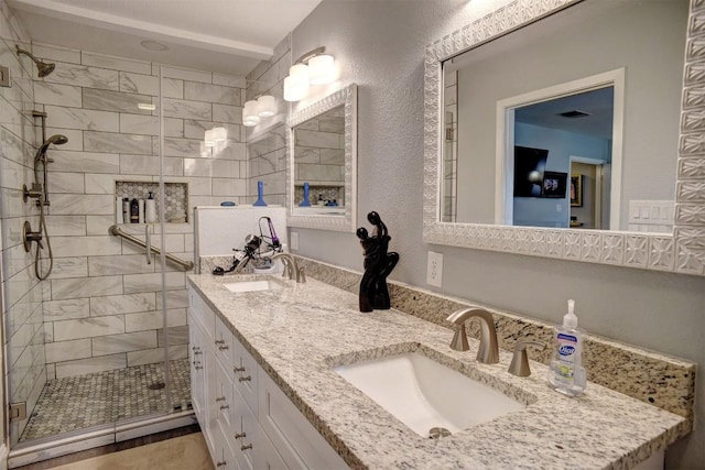 569 Mcallister Rd, Bastrop, TX 78602 - full bathroom with a shower stall and double vanity