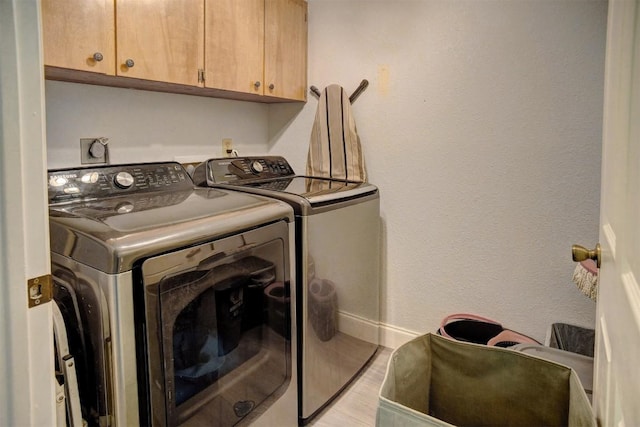 569 Mcallister Rd, Bastrop, TX 78602 - laundry area with independent washer and dryer, cabinet space, and light wood-style flooring