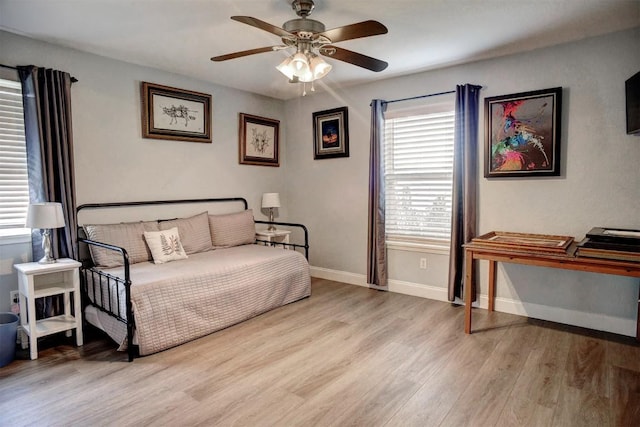 569 Mcallister Rd, Bastrop, TX 78602 - bedroom featuring multiple windows, light wood-style flooring, and ceiling fan