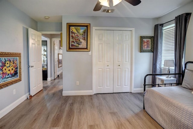 569 Mcallister Rd, Bastrop, TX 78602 - bedroom featuring light wood-style floors, a closet, and ceiling fan