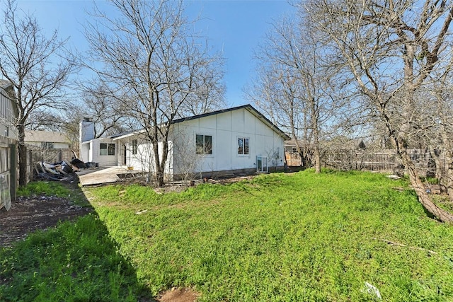3810 Leafield Dr, Austin, TX 78749 - rear view of house featuring a fenced backyard, board and batten siding, a patio area, and a chimney
