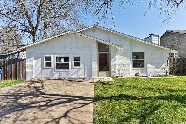 3810 Leafield Dr, Austin, TX 78749 - view of front of home with brick siding, a chimney, and driveway