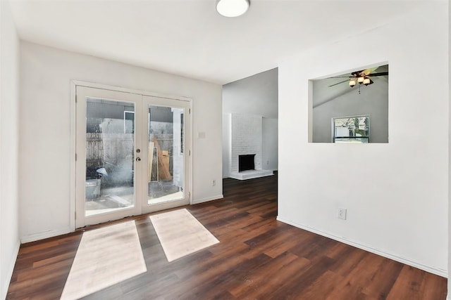 3810 Leafield Dr, Austin, TX 78749 - unfurnished room with french doors, dark wood-style flooring, a ceiling fan, lofted ceiling, and a fireplace