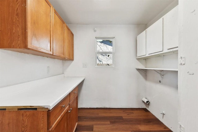3810 Leafield Dr, Austin, TX 78749 - laundry area featuring dark wood-style floors, hookup for an electric dryer, gas dryer hookup, and cabinet space