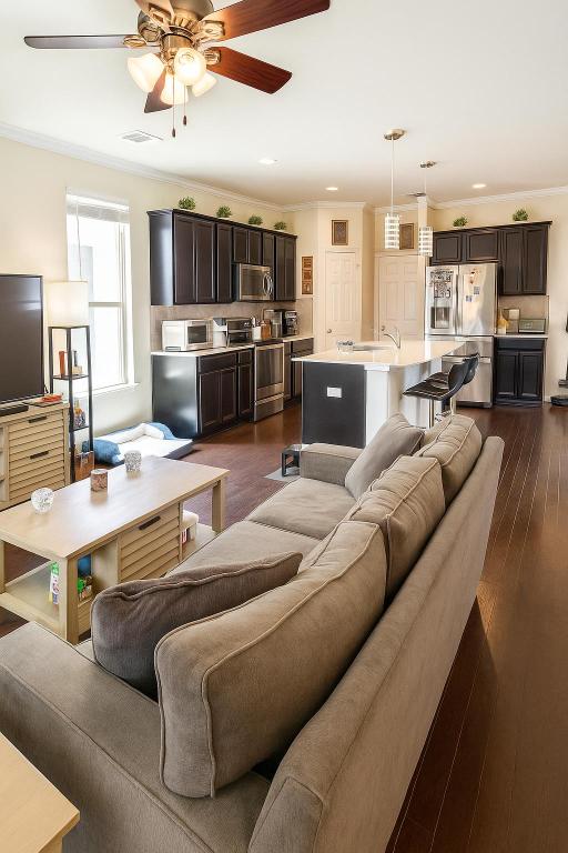 16021 Remington Reserve Way, Austin, TX 78728 - living area featuring a ceiling fan, dark wood-style floors, ornamental molding, and recessed lighting
