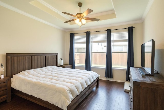16021 Remington Reserve Way, Austin, TX 78728 - bedroom with a tray ceiling, dark wood-style flooring, ornamental molding, and a ceiling fan