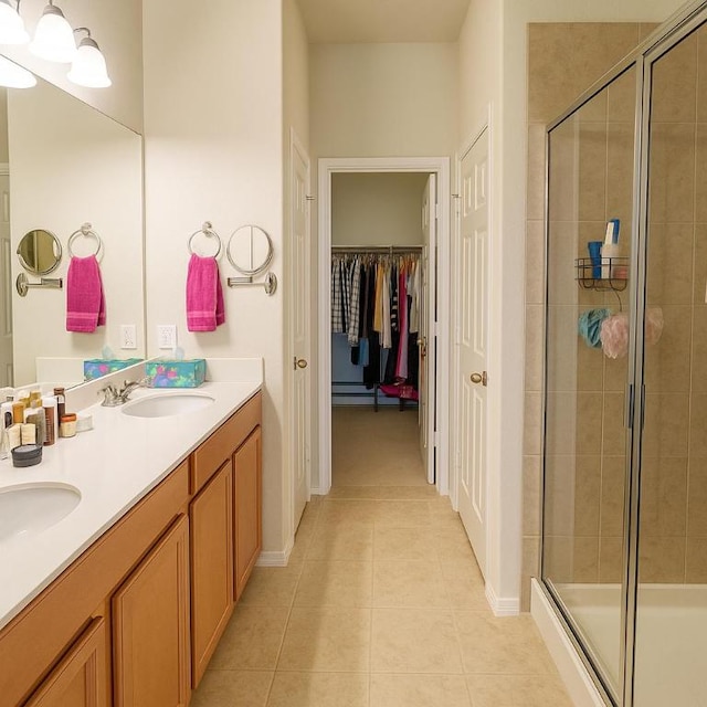 16021 Remington Reserve Way, Austin, TX 78728 - bathroom featuring tile patterned flooring, a stall shower, double vanity, and a spacious closet