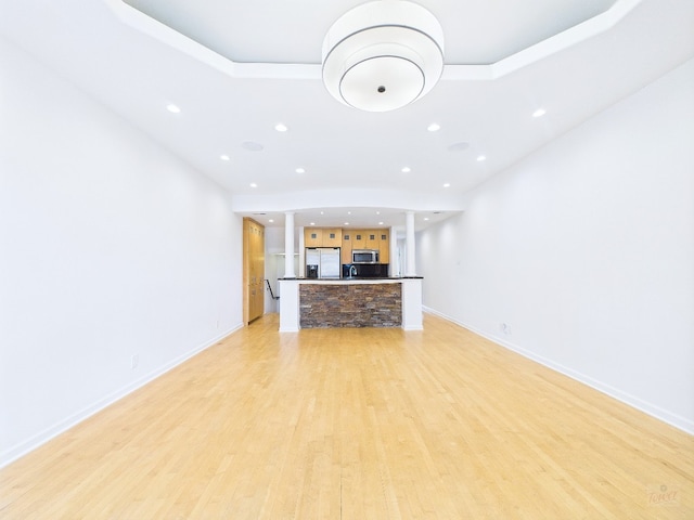 1501 Barton Springs Rd Unit 222, Austin, TX 78704 - unfurnished living room featuring decorative columns, light wood finished floors, and recessed lighting