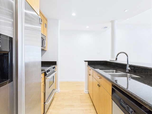 1501 Barton Springs Rd Unit 222, Austin, TX 78704 - kitchen with appliances with stainless steel finishes, dark stone countertops, light wood finished floors, light brown cabinets, and recessed lighting