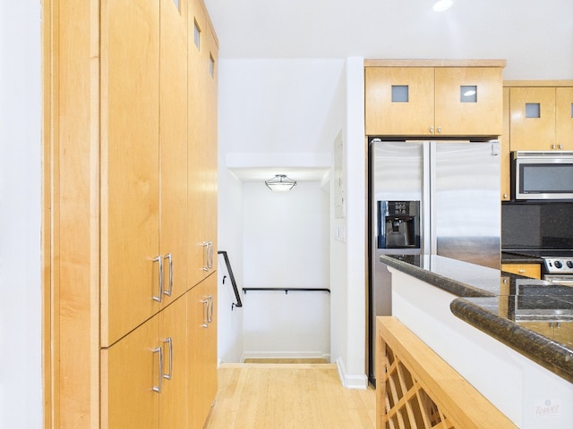 1501 Barton Springs Rd Unit 222, Austin, TX 78704 - kitchen with stainless steel appliances, dark stone counters, and light wood-type flooring