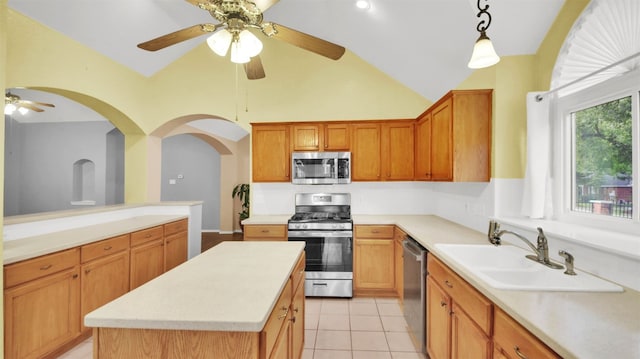 606 Dundalk Bay Cv, Pflugerville, TX 78660 - kitchen featuring stainless steel appliances, a ceiling fan, light countertops, hanging light fixtures, and light tile patterned floors