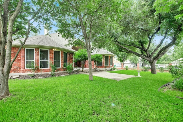 606 Dundalk Bay Cv, Pflugerville, TX 78660 - back of house with a yard, brick siding, and a patio
