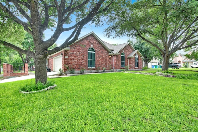 606 Dundalk Bay Cv, Pflugerville, TX 78660 - view of front of home featuring brick siding, a garage, a front lawn, and driveway