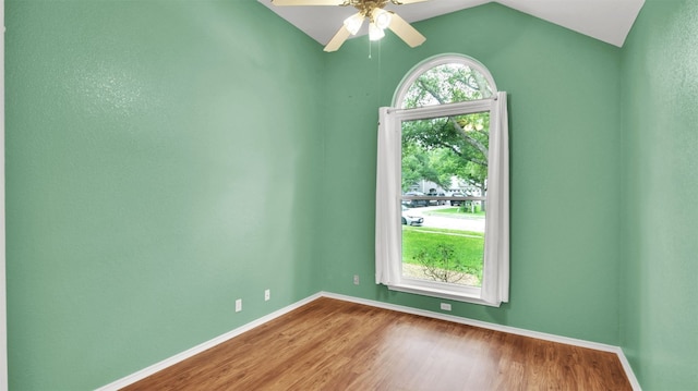 606 Dundalk Bay Cv, Pflugerville, TX 78660 - empty room featuring wood finished floors, ceiling fan, and vaulted ceiling