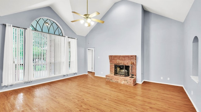 606 Dundalk Bay Cv, Pflugerville, TX 78660 - unfurnished living room with light wood finished floors, ceiling fan, a brick fireplace, and high vaulted ceiling