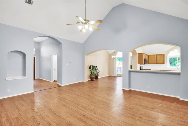 606 Dundalk Bay Cv, Pflugerville, TX 78660 - unfurnished living room featuring a ceiling fan, high vaulted ceiling, and light wood finished floors