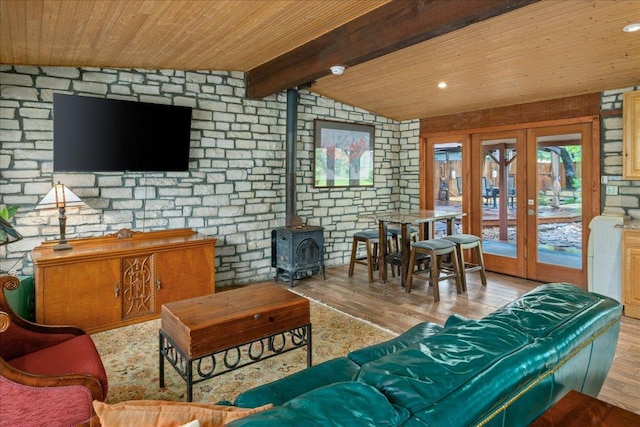 601 Robin Nest, Canyon Lake, TX 78133 - living area featuring french doors, wood finished floors, wooden ceiling, a wood stove, and brick wall