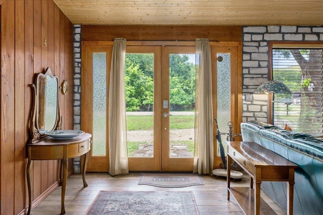 601 Robin Nest, Canyon Lake, TX 78133 - entryway with french doors, wood walls, healthy amount of natural light, light wood finished floors, and wooden ceiling