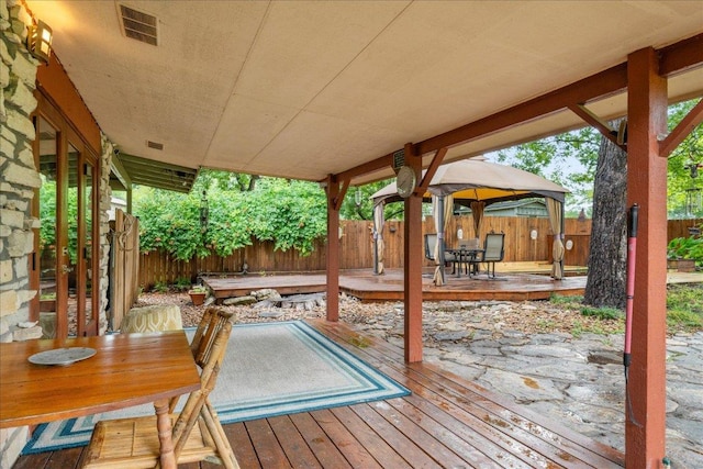 601 Robin Nest, Canyon Lake, TX 78133 - wooden deck featuring outdoor dining space, a fenced backyard, and a gazebo