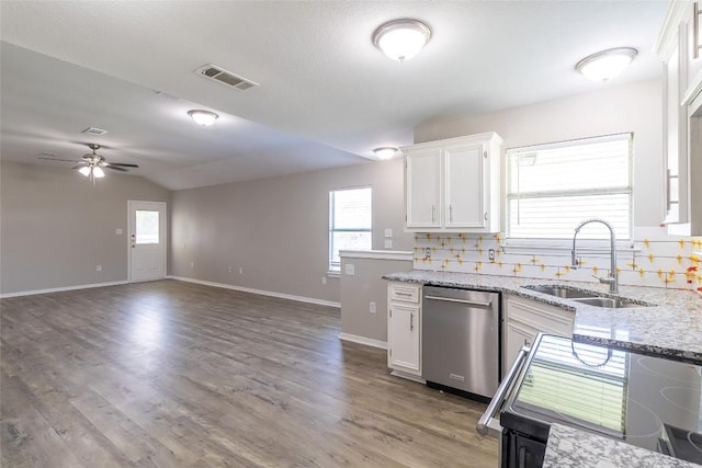 706 Brown St, Lampasas, TX 76550 - kitchen with stainless steel dishwasher, white cabinetry, a ceiling fan, light stone countertops, and plenty of natural light