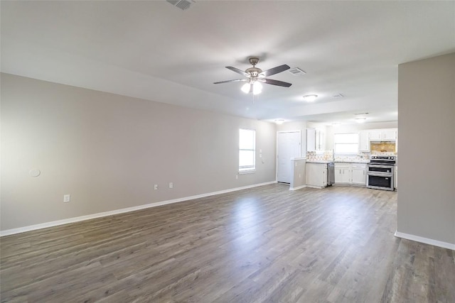 706 Brown St, Lampasas, TX 76550 - unfurnished living room featuring ceiling fan and dark wood-style flooring