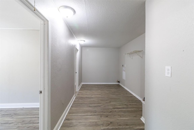 706 Brown St, Lampasas, TX 76550 - laundry area with wood finished floors, a textured ceiling, and a textured wall