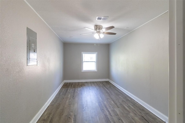 706 Brown St, Lampasas, TX 76550 - unfurnished room featuring electric panel, dark wood-style floors, ceiling fan, and a textured wall