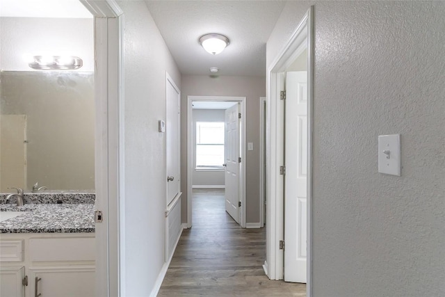 706 Brown St, Lampasas, TX 76550 - corridor featuring light wood-style flooring and a textured wall